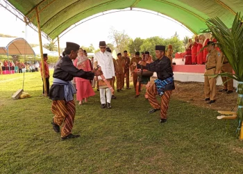 HUT Kecamatan Posigadan ke-20, Bupati dan Ketua TP PKK Bolsel di Jemput Pakai Adat